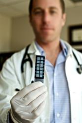 Dr. Colby holding Existence Genetics' Nexus DNA Chip